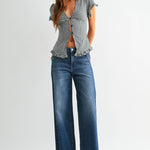 Dark wash wide leg jeans with a raw hem finish