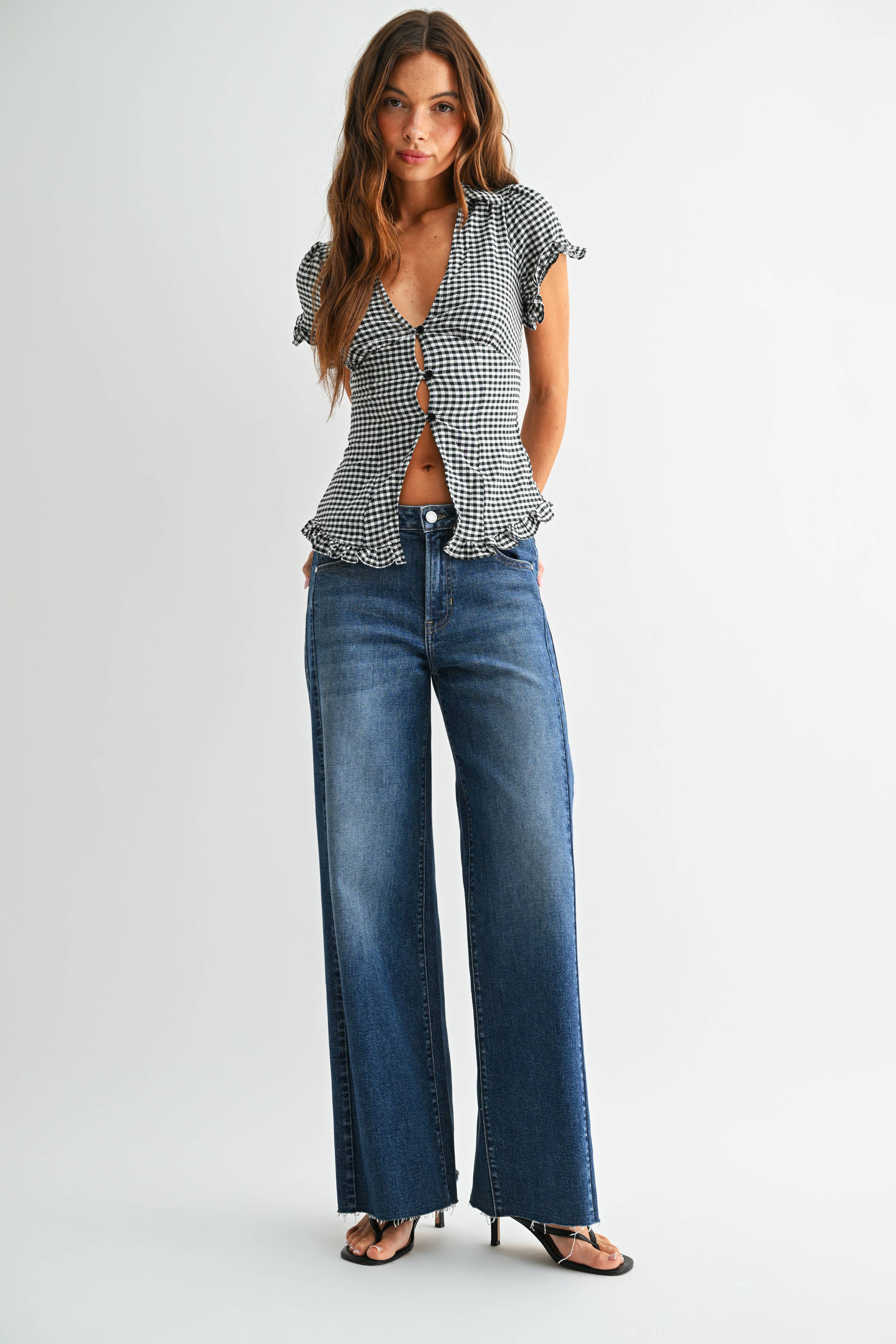 Dark wash wide leg jeans with a raw hem finish