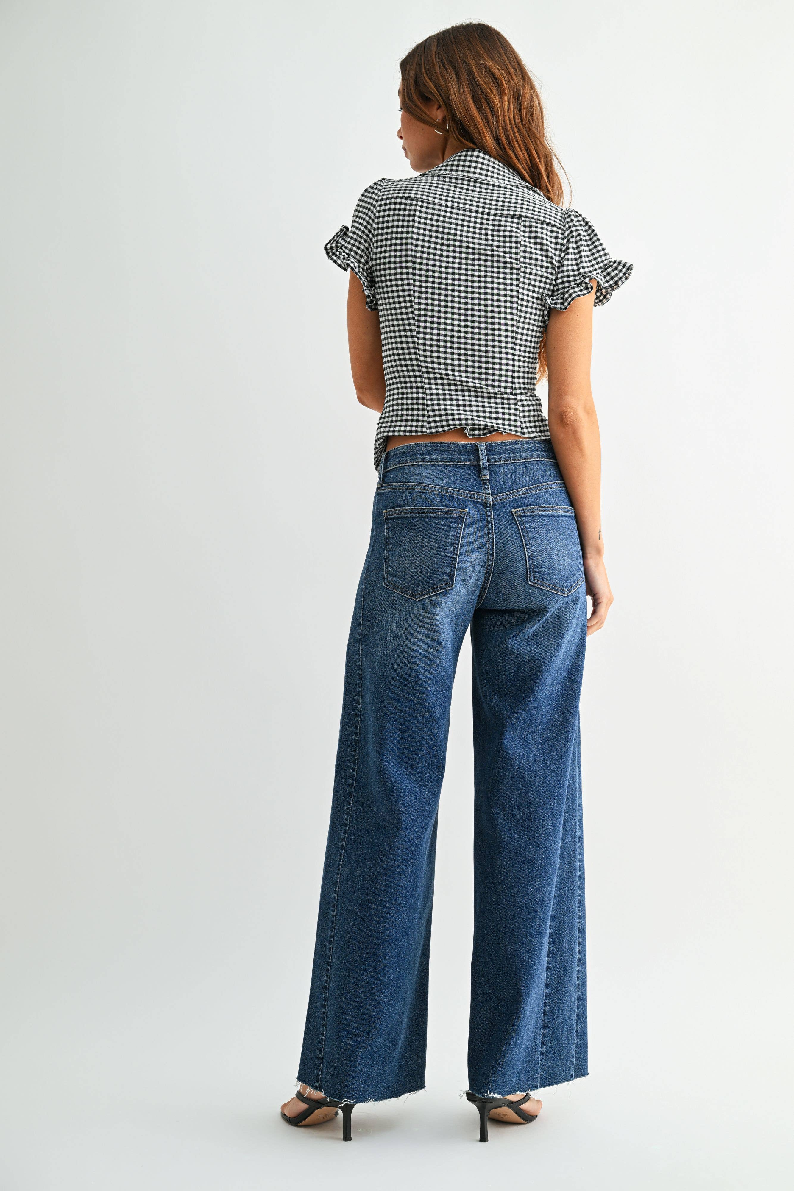 Dark wash wide leg jeans with a raw hem finish