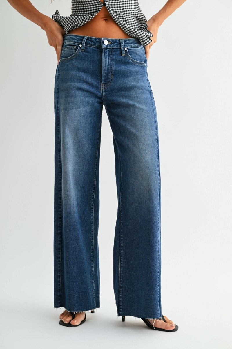 Dark wash wide leg jeans with a raw hem finish