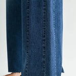 Dark wash wide leg jeans with a raw hem finish