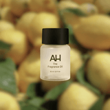 Bottle of Aura House Happy fragrance oil, a crisp citrus and marine scent