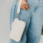 Black woven vegan leather clutch with a wristlet strap