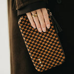 Black woven vegan leather clutch with a wristlet strap