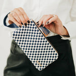 Black woven vegan leather clutch with a wristlet strap
