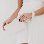 Black woven vegan leather clutch with a wristlet strap