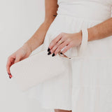 Black woven vegan leather clutch with a wristlet strap