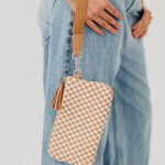 Black woven vegan leather clutch with a wristlet strap