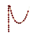 Fabric pom pom garland with a gold finish in burgundy and pink