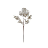 A faux juniper branch in brown with a snow finish