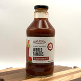 Bottle of Galena Canning Co. World Famous Bloody Mary Mix on a wooden surface with a white background
