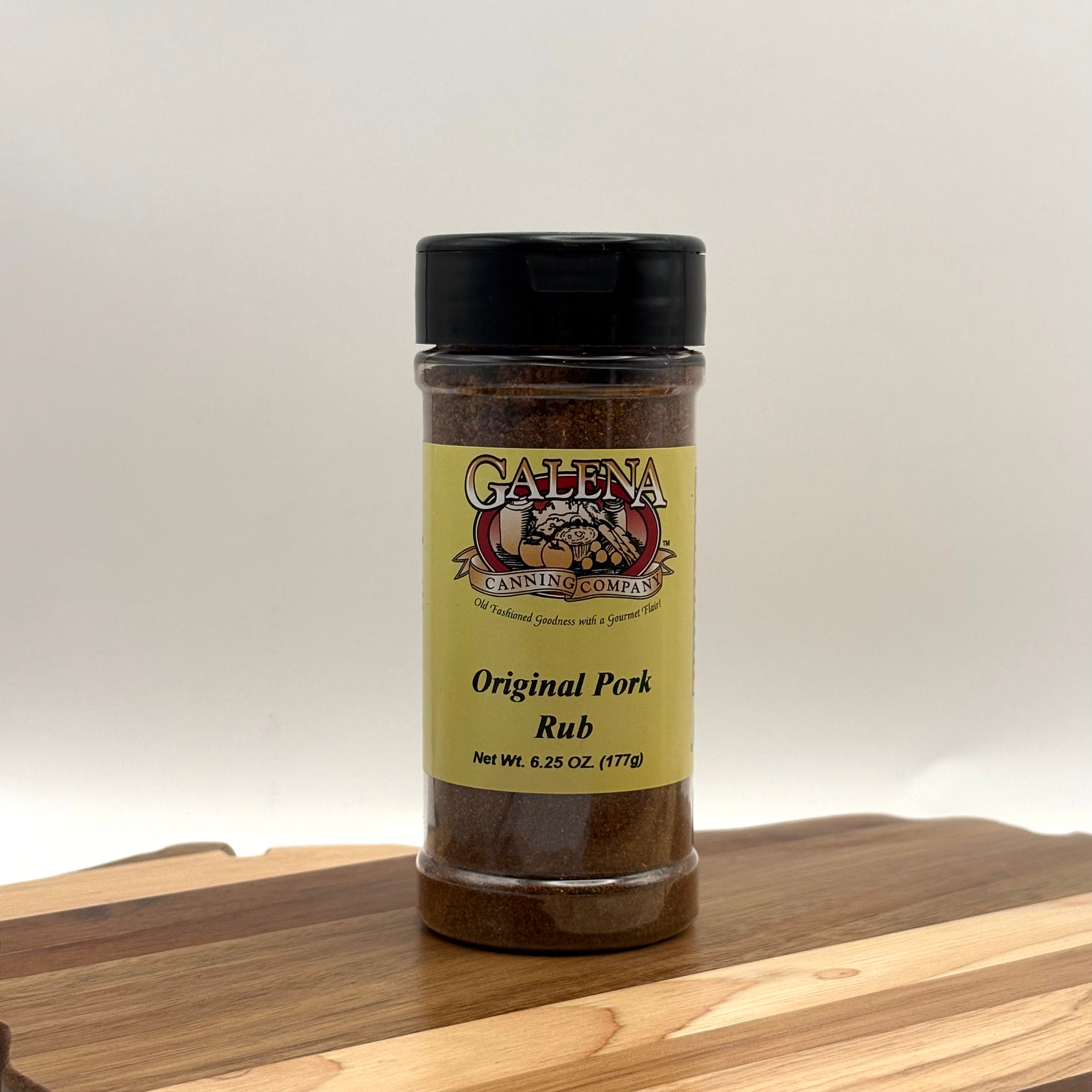 Jar of Galena Canning Company Original Pork Rub on a wooden surface with a white background