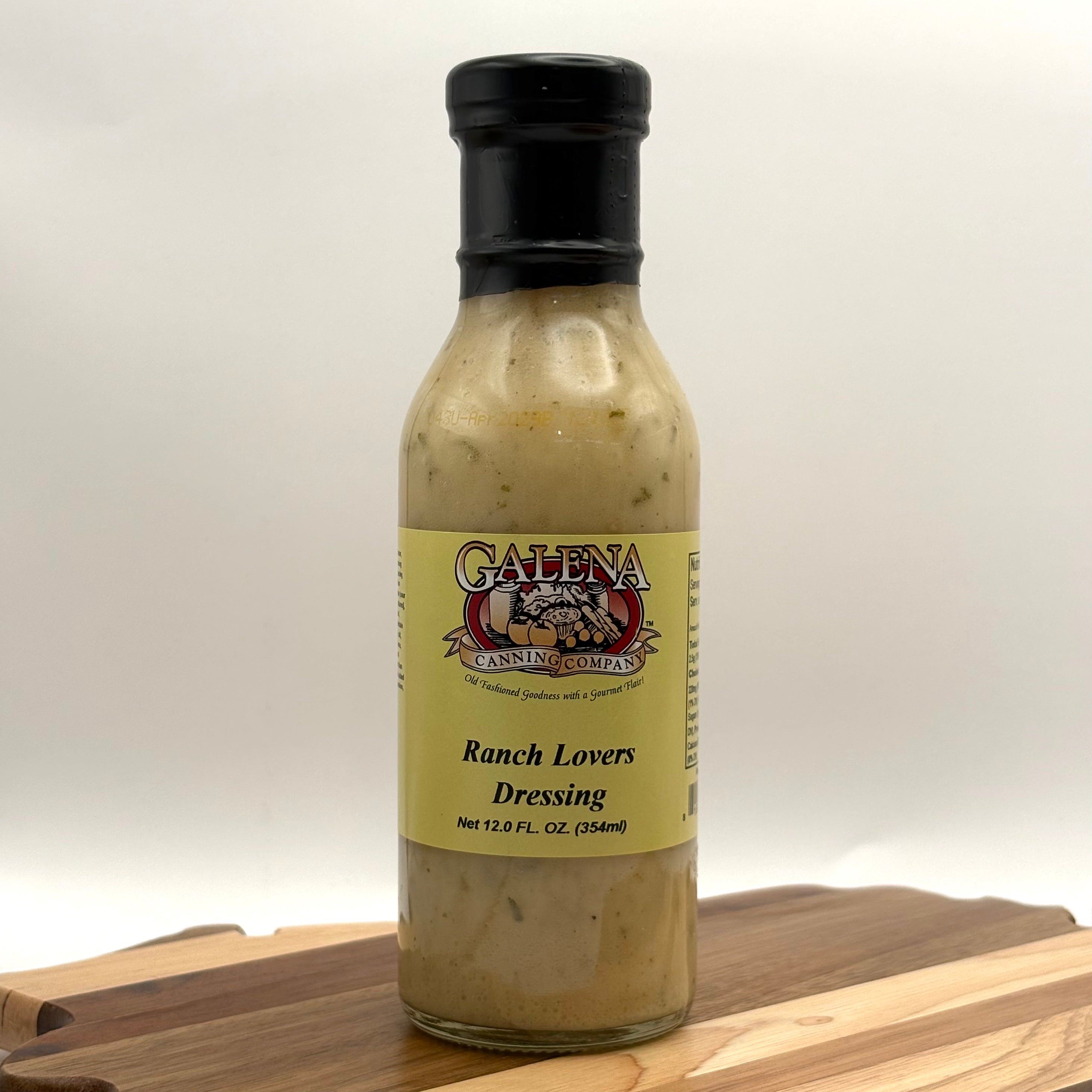 Bottle of Galena Ranch Lovers Dressing on a wooden surface with a white background
