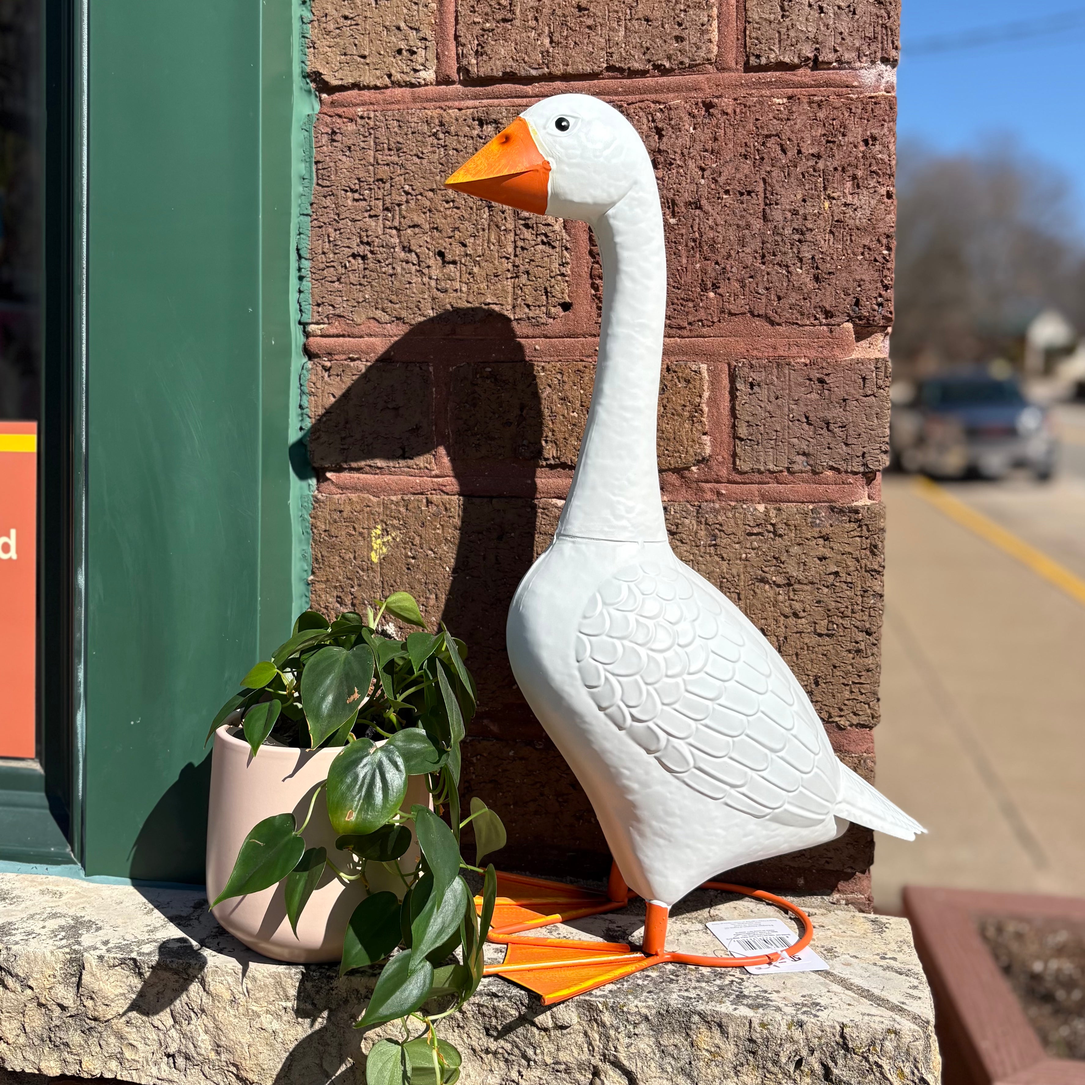Giddy the porch goose statue on a front porch