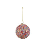 A glass ball ornament covered in beads and glitter