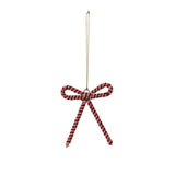 A metal bow-shaped ornament decorated with glass beads
