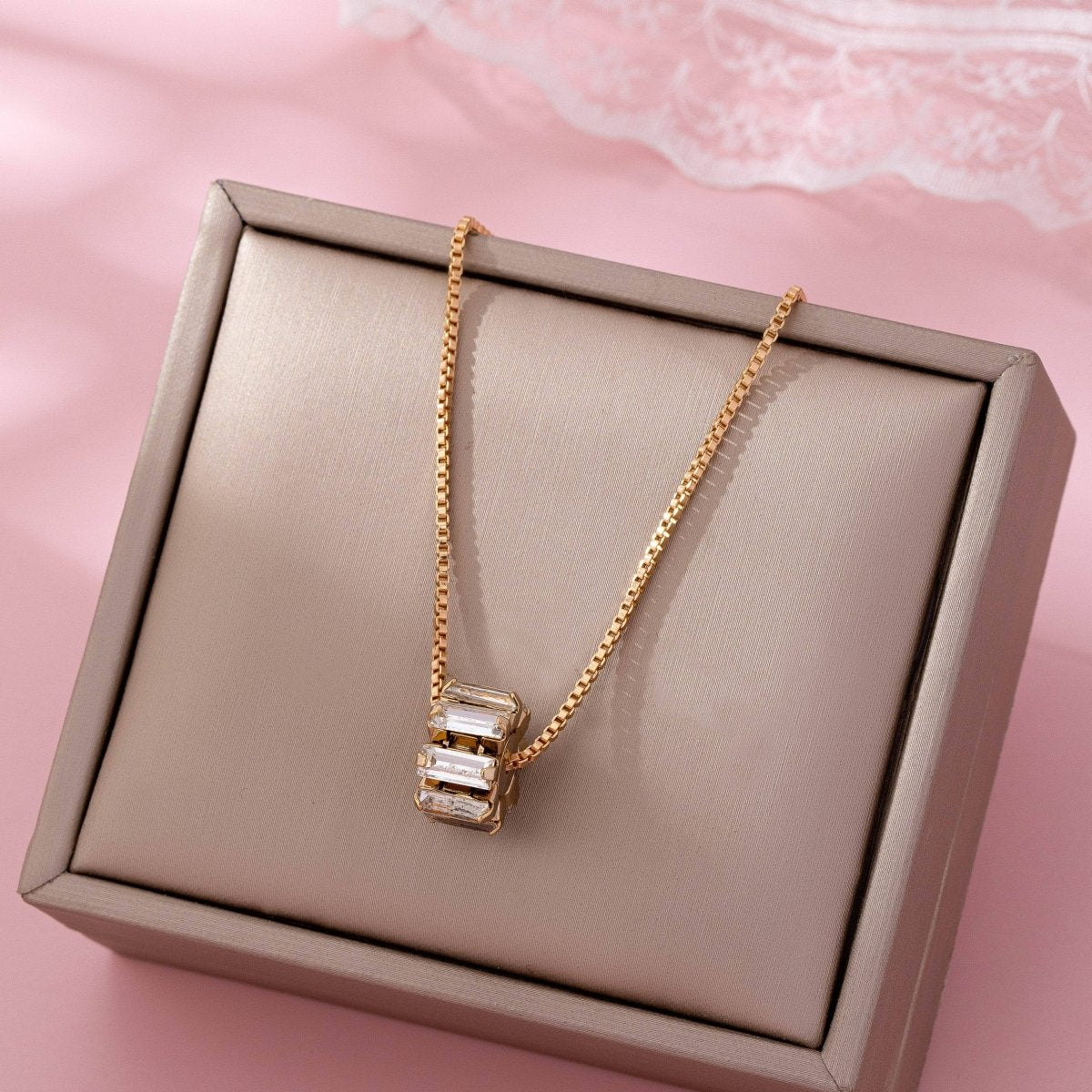 Gold-tone necklace with baguette crystal barrel pendant