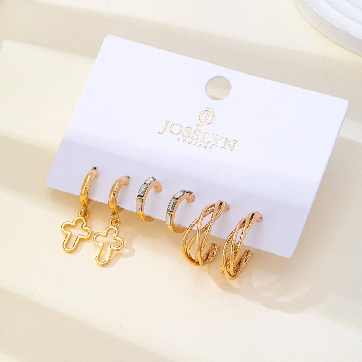 Gold-tone hoop earring trio set with cross and baguette accents