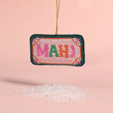 Decorative ornament with 'MAHJ' text on a pink background