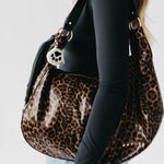 Tan suede hobo shoulder bag with a tassel