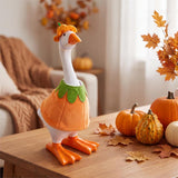 Table-sized goose figurine dressed in a holiday outfit