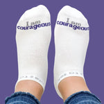 White socks with 'I am courageous' text on a purple background