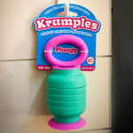 Mint green and pink Krumples Plungy toy on a tiled background. 
