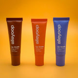 Three tubes of alleyoop lip balm on a yellow background