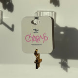 Cross keychain with 'CHARMS' charm on a card labeled 'little words project' against a light background