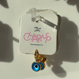 Evil eye charm on a 'little words project' card with pink text.