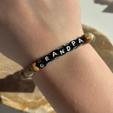 Little Words Project Bracelet with 'GRANDPA' on a wrist against a neutral background