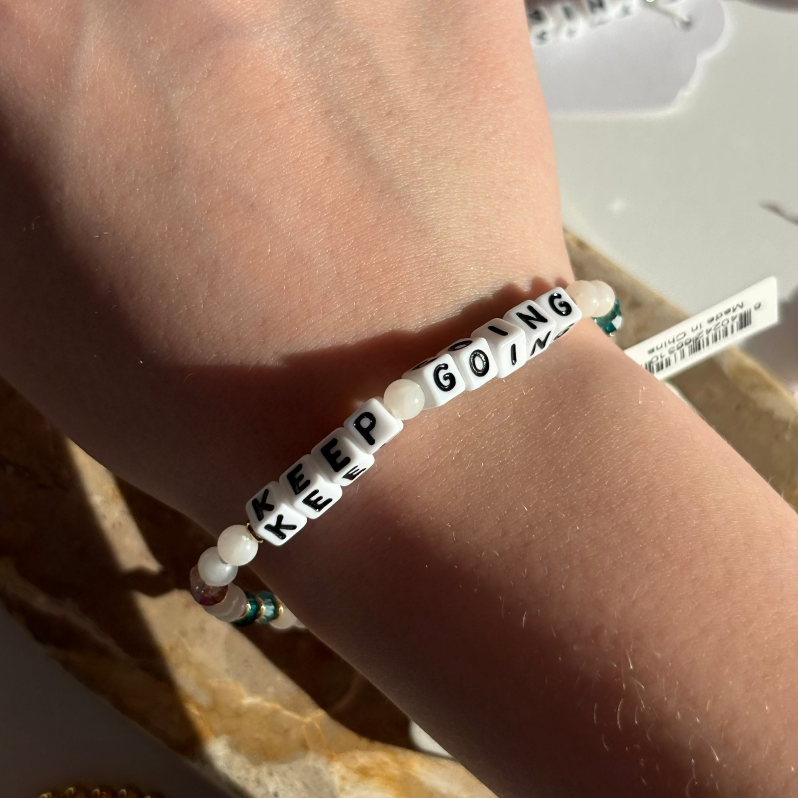 Little Words Project Bracelet with 'KEEP GOING' message on wrist 