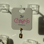 Gold number 0 charm on a 'little words project' card with clear hooks in the background
