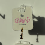 Gold number 1 charm with number '1' on a 'little words project CHARMS' card.