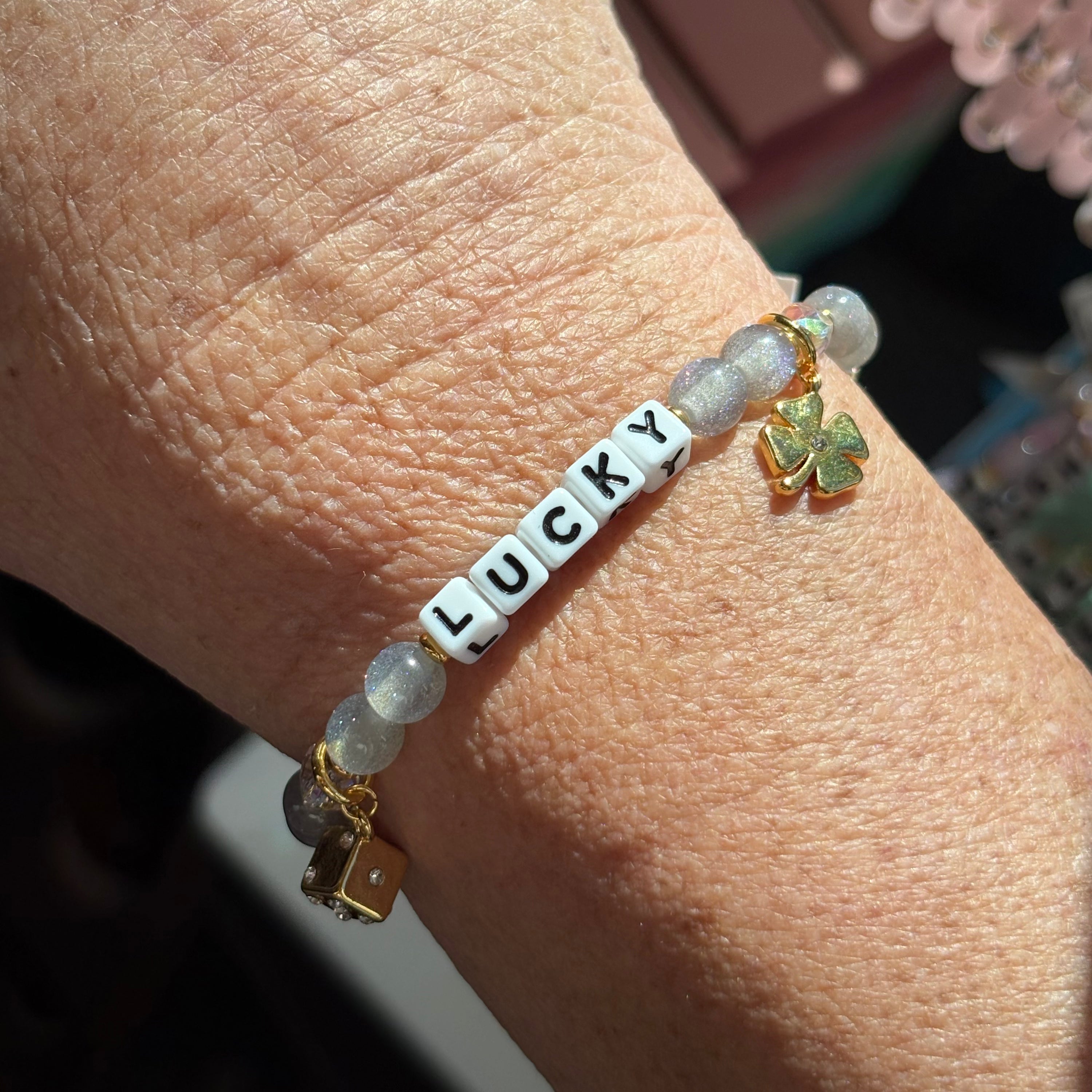 Little words bracelet with 'LUCKY' charm on a wrist