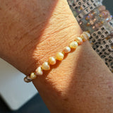 Pearl bracelet on a wrist with a blurred background