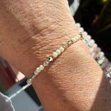Close-up of a beaded bracelet on a wrist with a blurred background