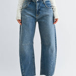 Medium wash barrel jeans with seam detailing and a raw hem