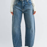 Medium wash barrel jeans with seam detailing and a raw hem
