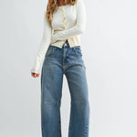 Medium wash barrel jeans with seam detailing and a raw hem
