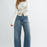 Medium wash barrel jeans with seam detailing and a raw hem