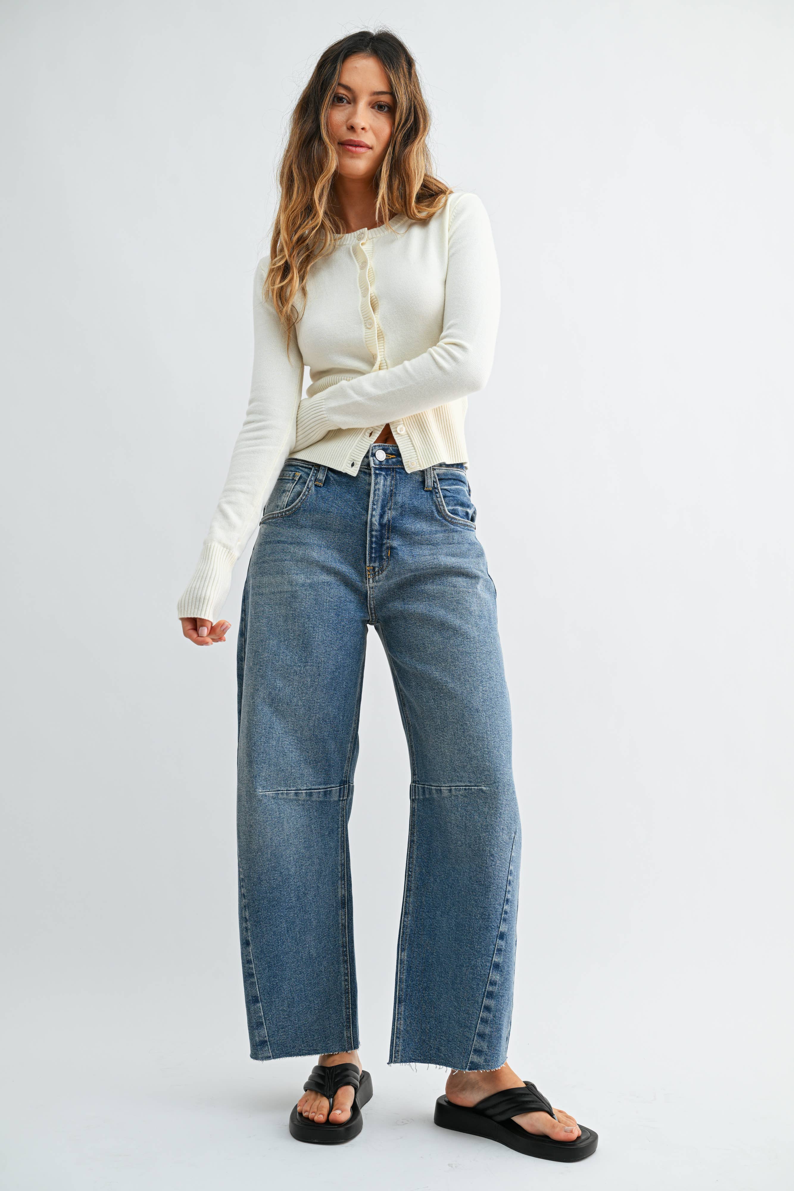 Medium wash barrel jeans with seam detailing and a raw hem