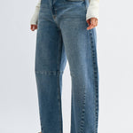 Medium wash barrel jeans with seam detailing and a raw hem