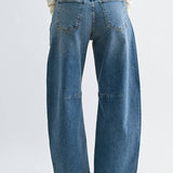 Medium wash barrel jeans with seam detailing and a raw hem