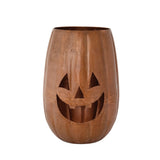 A metal candle holder shaped like a jack-o-lantern with decorative cut-outs