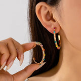 Multi-color gemstone hoop earrings in gold-tone