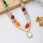 Multi-color stone and crystal pendant necklace in green, pink, and burgundy