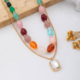Multi-color stone and crystal pendant necklace in green, pink, and burgundy