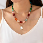 Multi-color stone and crystal pendant necklace in green, pink, and burgundy