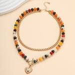 Multi layer gold-tone necklace with resin beaded pendant